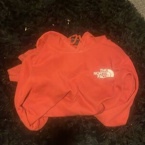 This is an orange north face hoodie.